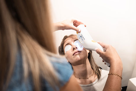 Applying eye drops to dry eye